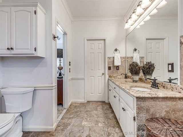 bathroom featuring vanity, toilet, and crown molding