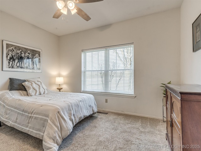 bedroom featuring ceiling fan and light carpet