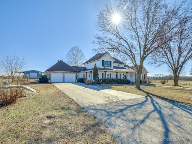 view of front of property with a garage and a front yard