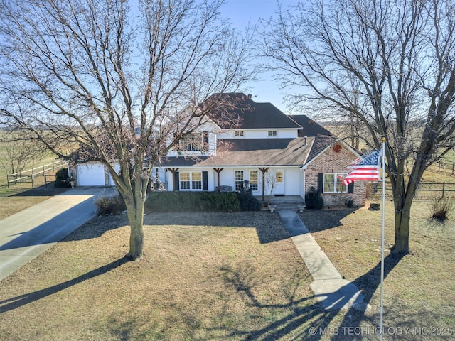 view of front of property featuring a garage and a front lawn