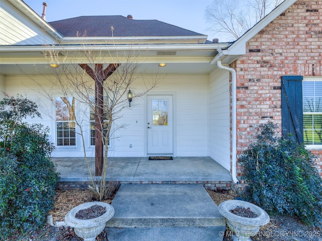 entrance to property featuring a porch