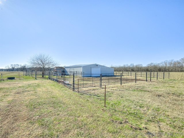 view of yard with an outbuilding and a rural view