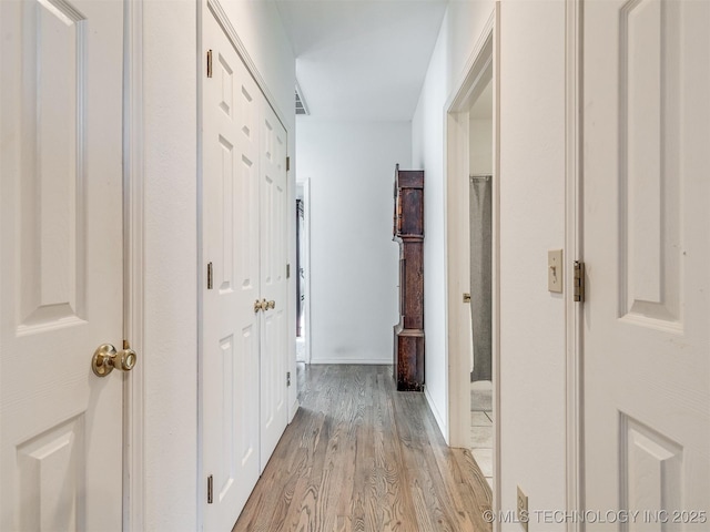 hallway with light hardwood / wood-style flooring