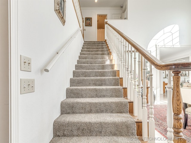 staircase featuring ornamental molding