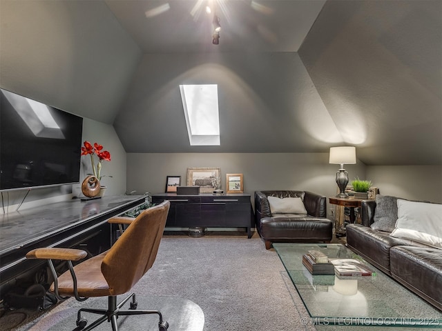 carpeted home office with lofted ceiling with skylight