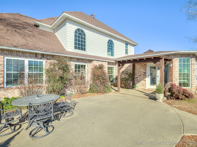 rear view of property featuring a patio area