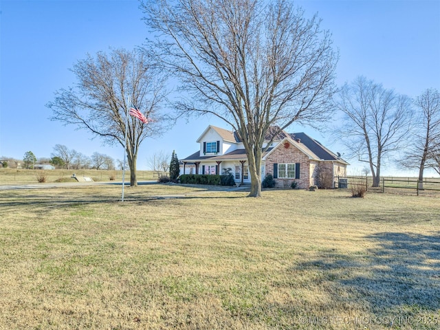 view of front of property with a front yard and a rural view