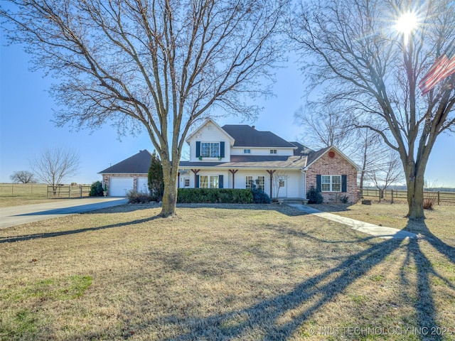 view of front of house with a garage and a front lawn