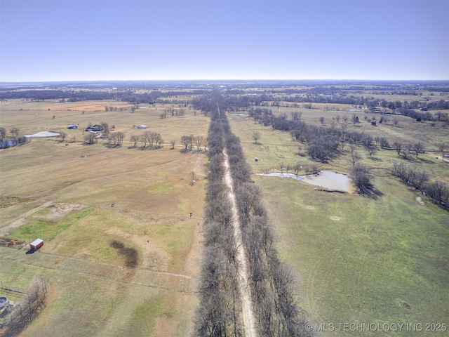 birds eye view of property featuring a water view and a rural view