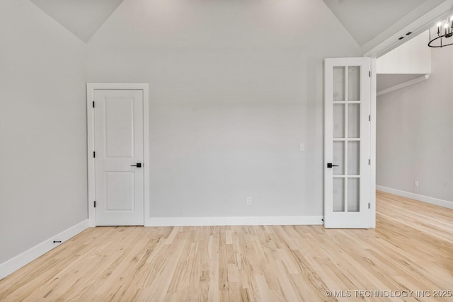 4006 S Dogwood Pl, Broken Arrow, OK 74012 - unfurnished room featuring vaulted ceiling, wood finished floors, baseboards, french doors, and a chandelier