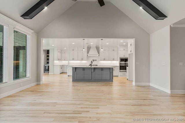 4006 S Dogwood Pl, Broken Arrow, OK 74012 - kitchen with premium range hood, high vaulted ceiling, appliances with stainless steel finishes, white cabinets, and light countertops