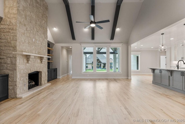 4006 S Dogwood Pl, Broken Arrow, OK 74012 - unfurnished living room with a ceiling fan, a fireplace, beam ceiling, light wood-style flooring, and baseboards