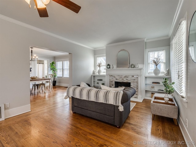 living room with ornamental molding, ceiling fan, and hardwood / wood-style flooring