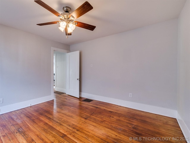 spare room featuring ceiling fan and hardwood / wood-style flooring