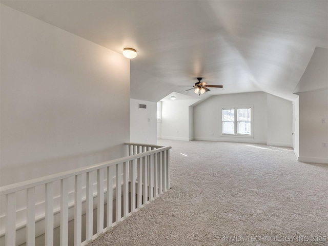 bonus room featuring ceiling fan, vaulted ceiling, and carpet flooring