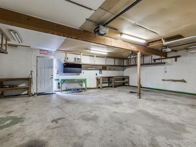 garage featuring a garage door opener and a workshop area