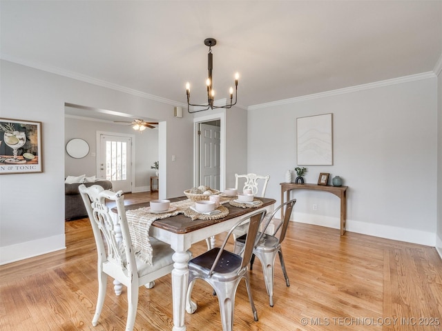 dining room with ceiling fan with notable chandelier, light wood-type flooring, and crown molding