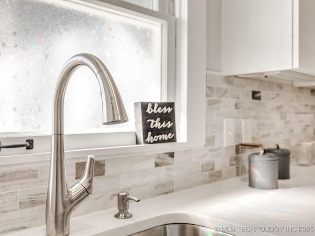 details with tasteful backsplash and white cabinetry