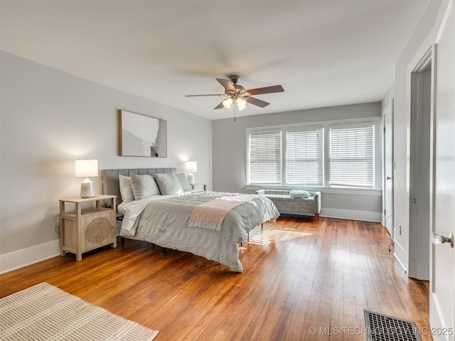 bedroom with hardwood / wood-style floors and ceiling fan