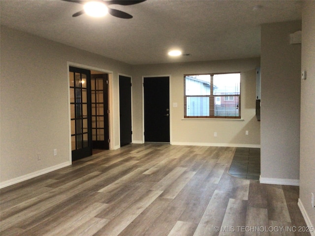 unfurnished room with ceiling fan and wood-type flooring