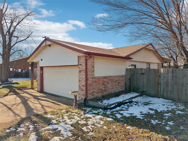 view of snowy exterior with a garage