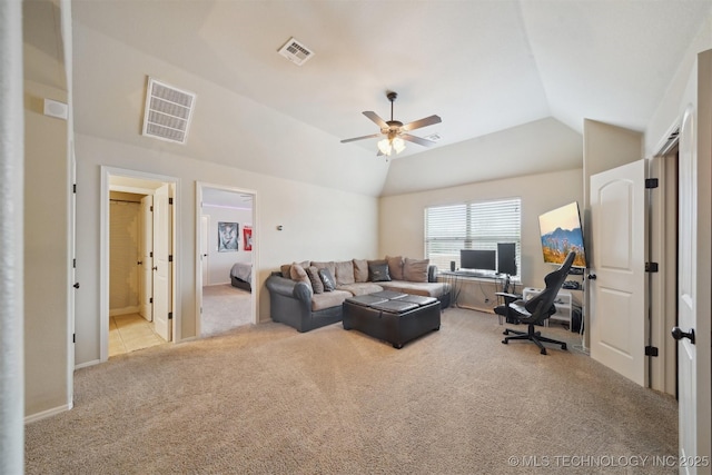 living room with lofted ceiling, ceiling fan, and light colored carpet