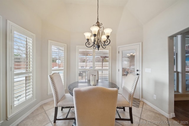 tiled dining area featuring a notable chandelier and vaulted ceiling