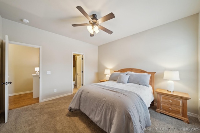 bedroom with ceiling fan, ensuite bath, and carpet