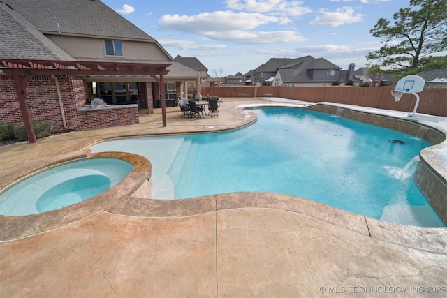 view of swimming pool featuring a patio and an in ground hot tub