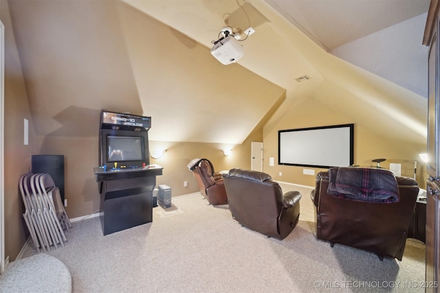 cinema room featuring carpet floors and vaulted ceiling