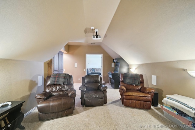 carpeted cinema room featuring lofted ceiling