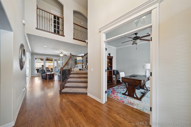 foyer entrance with ceiling fan, hardwood / wood-style floors, and ornamental molding