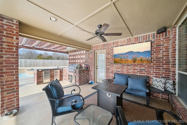 view of patio / terrace with an outdoor kitchen, area for grilling, and ceiling fan