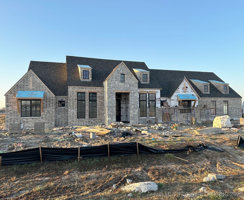 view of front of house featuring brick siding and stone siding