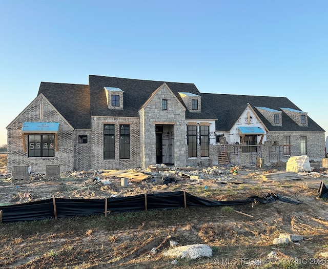 view of front of house featuring brick siding and stone siding