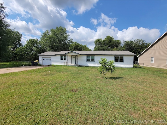 view of front of home with a front yard and a garage