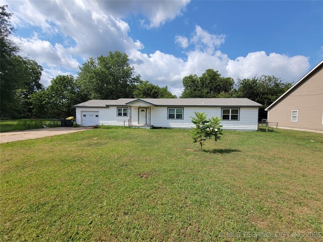 view of front of home with a front yard and a garage