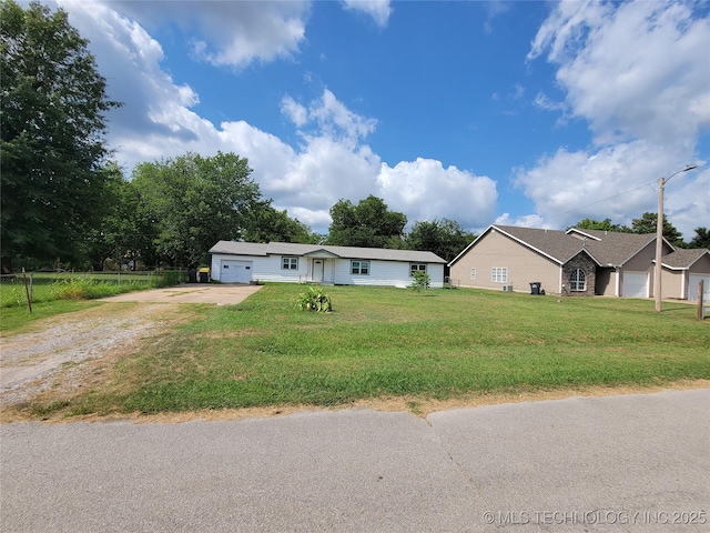 view of front of house with a garage and a front lawn