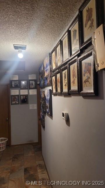 hallway with a textured ceiling