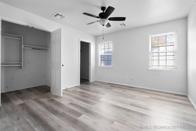 unfurnished bedroom with a closet, ceiling fan, and light hardwood / wood-style floors