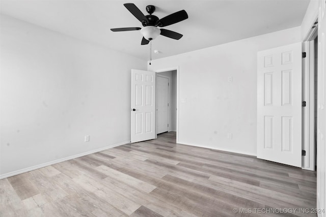 unfurnished bedroom featuring ceiling fan and light wood-type flooring