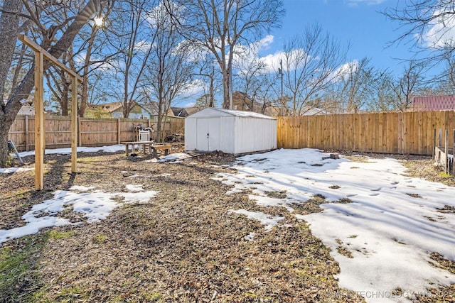 snowy yard with a shed