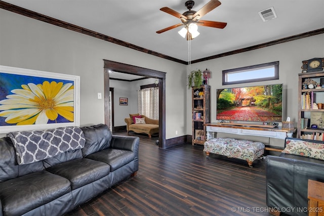 living room featuring ceiling fan, dark wood-type flooring, and crown molding