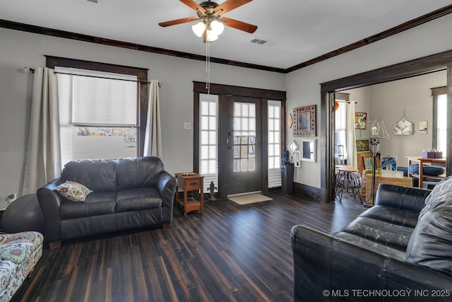 living room featuring dark wood-type flooring, ceiling fan, and crown molding