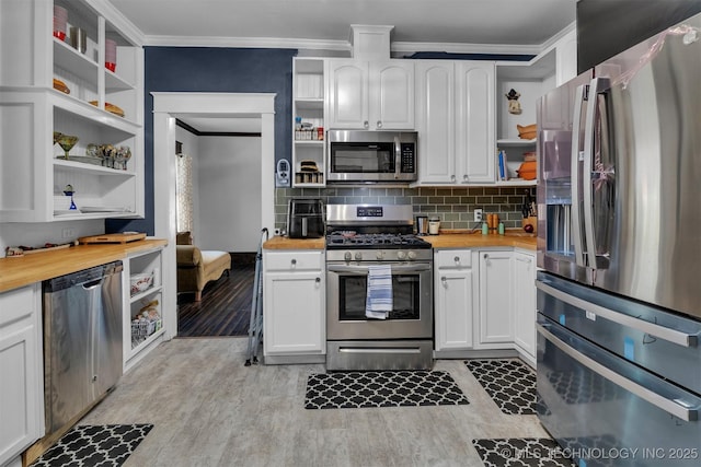 kitchen with stainless steel appliances, butcher block counters, and white cabinets