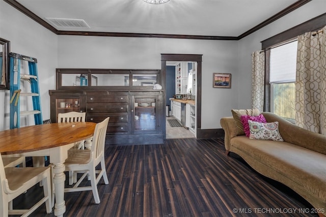 dining space featuring crown molding and dark hardwood / wood-style floors