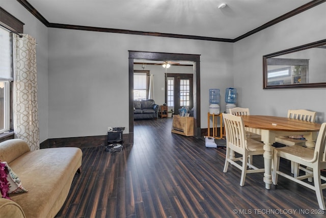 dining space featuring ceiling fan, dark wood-type flooring, and crown molding