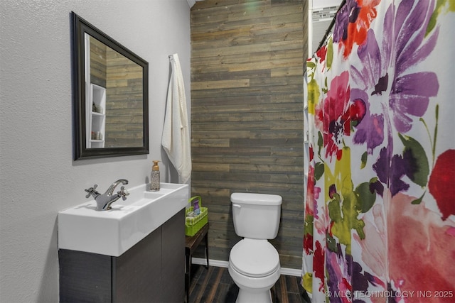 bathroom with toilet, a shower with shower curtain, vanity, and hardwood / wood-style flooring