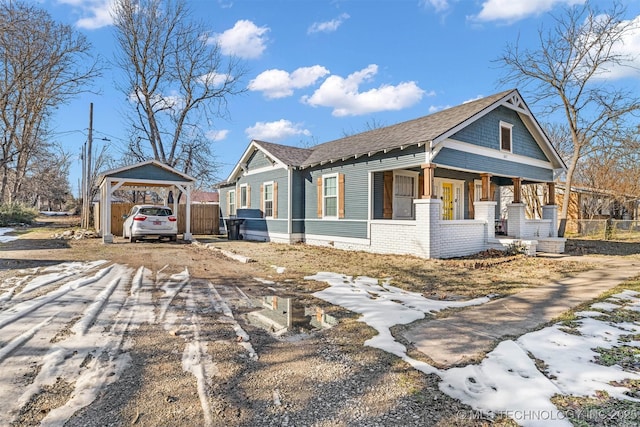 view of front of house featuring covered porch and a carport