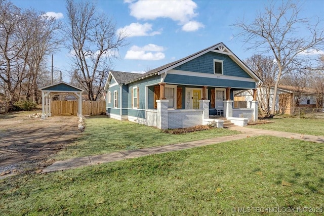 view of front of house with a front yard and a porch